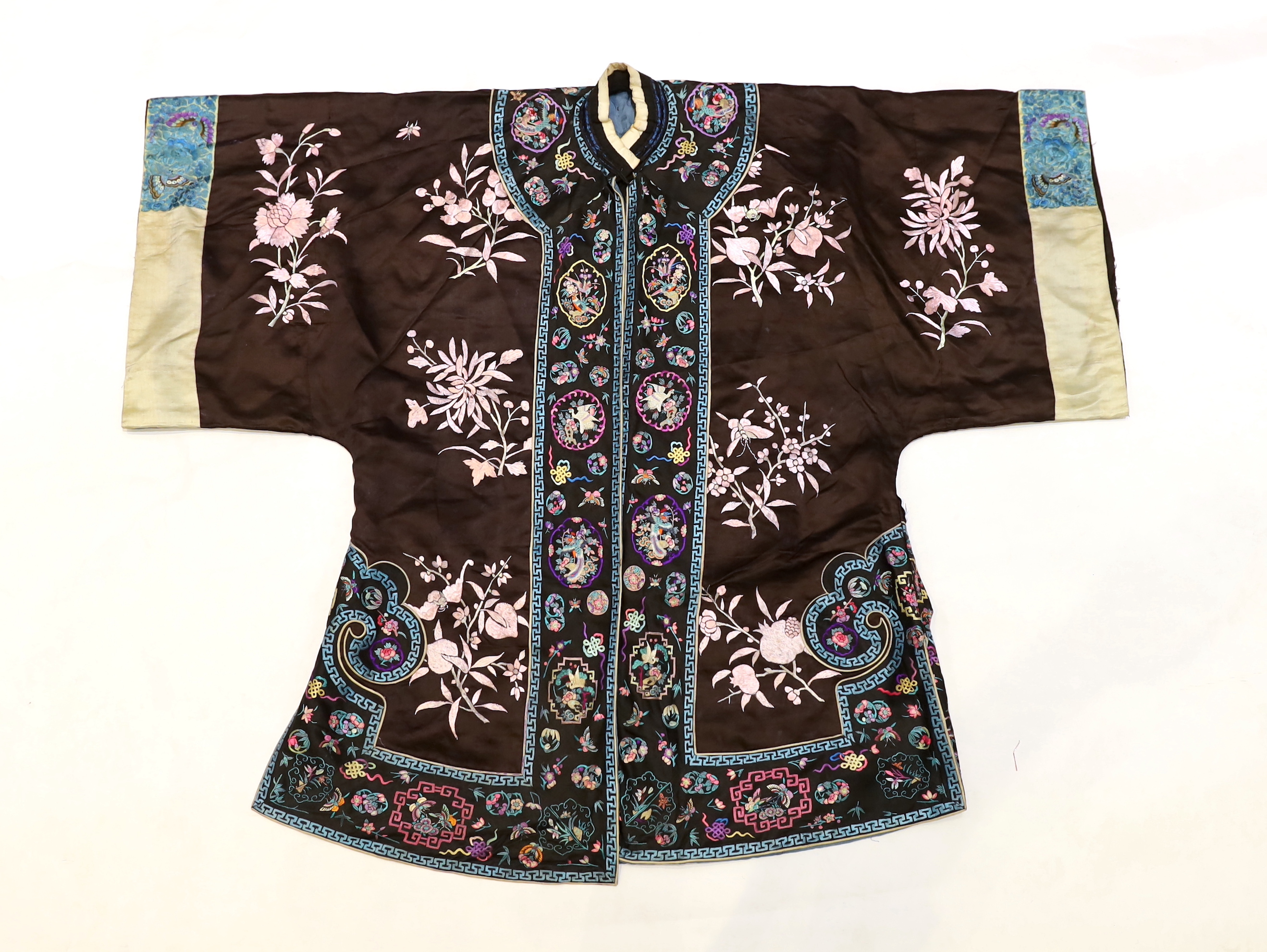 A Chinese early Republic blue silk embroidered robe with colourful ornately embroidered sleeve bands and borders to the robe